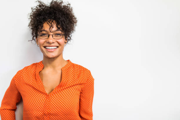 A woman with glasses and an orange shirt