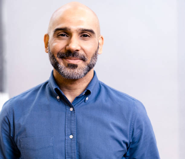 A man with a beard and blue shirt